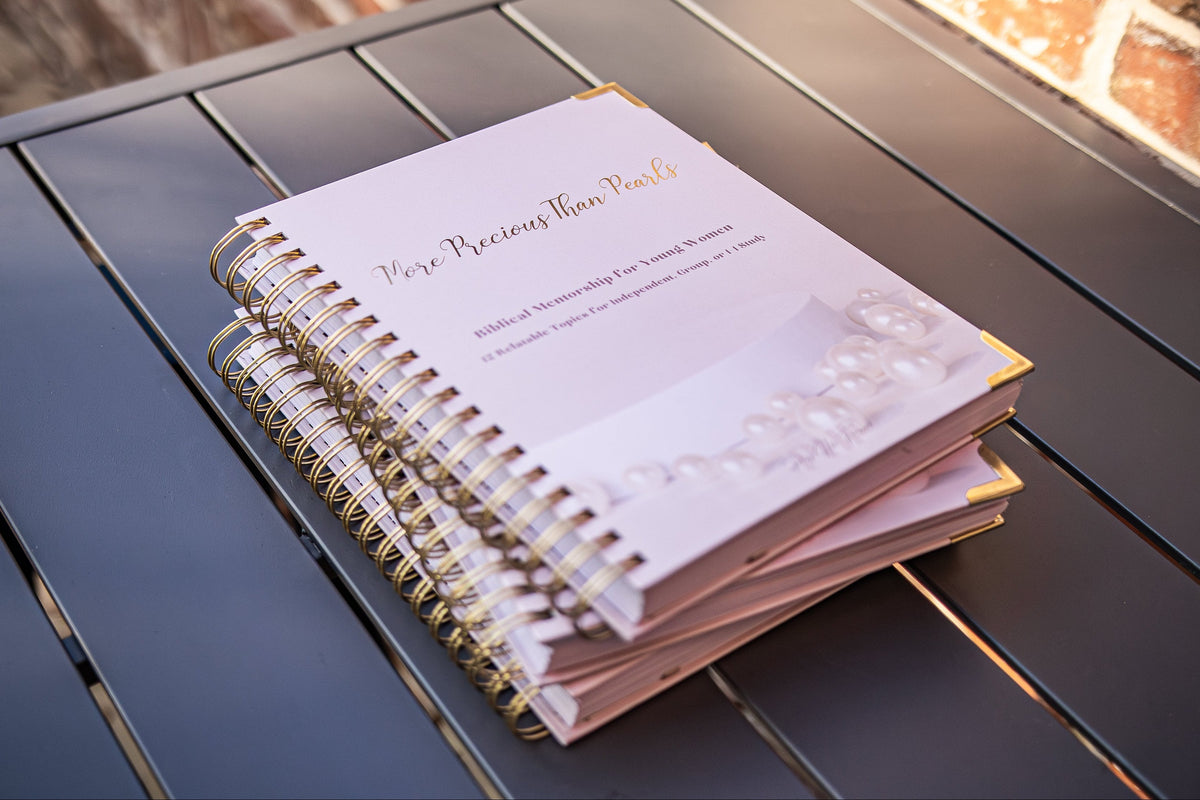 A stack of More Precious Than Pearls biblical mentorship curriculum