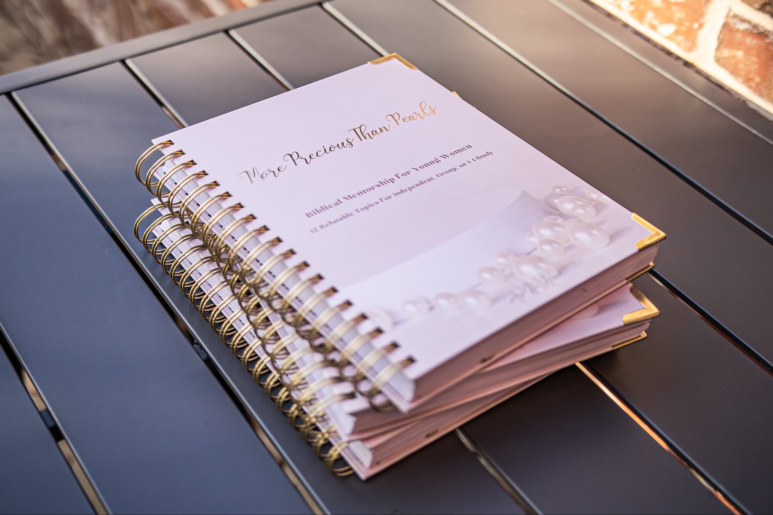 Stack of More Precious Than pearls mentorship curriculum books